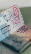 A passport filled with stamps sits open