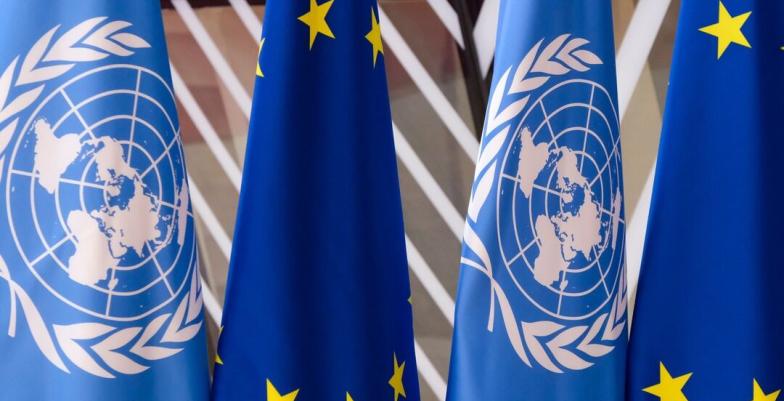 UN and EU flags side-by-side. 